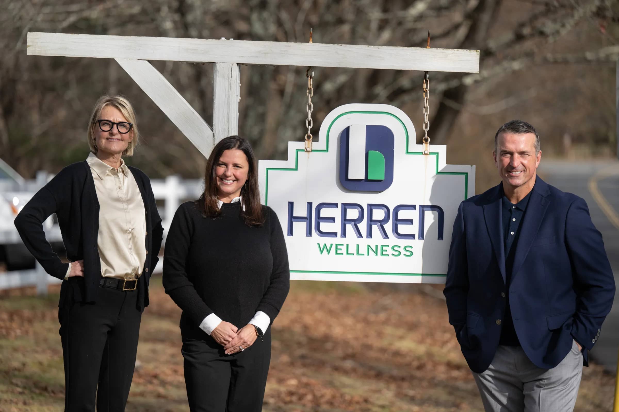 Lori McCarthy, Chris Herren, and Heather Herren standing together at Herren Wellness