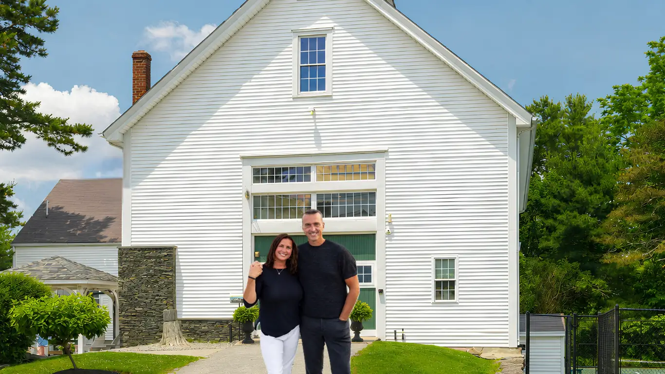 Chris and Heather Herren standing in front of the Herren Wellness barn